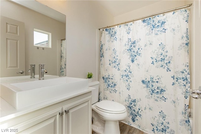 full bath featuring curtained shower, toilet, wood finished floors, and vanity