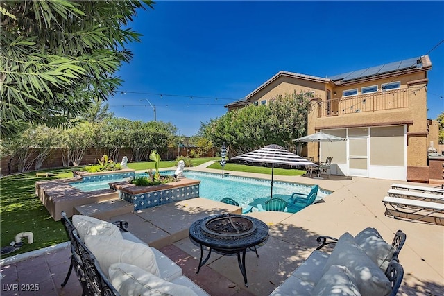 view of pool with a fenced in pool, a patio, a fenced backyard, and an outdoor fire pit