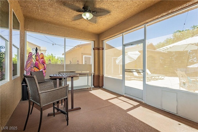 sunroom / solarium featuring ceiling fan