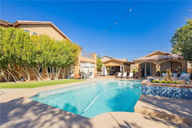 outdoor pool featuring a gazebo, an outdoor structure, a patio, and fence