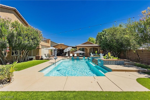 view of swimming pool with a patio area, a fenced in pool, and fence