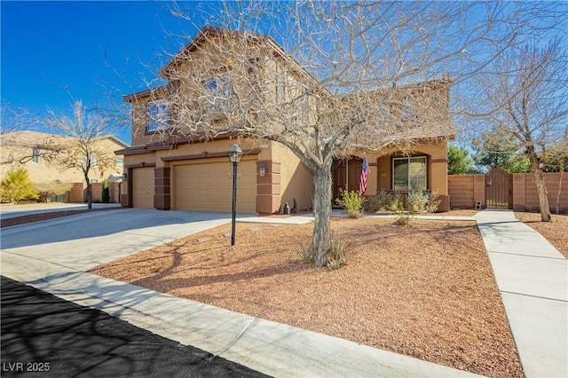 view of front of property featuring a gate, fence, stucco siding, concrete driveway, and a garage