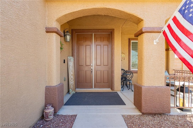 doorway to property with stucco siding