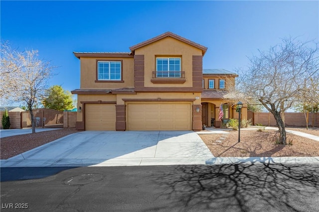 view of front of home with a gate, fence, driveway, an attached garage, and stucco siding