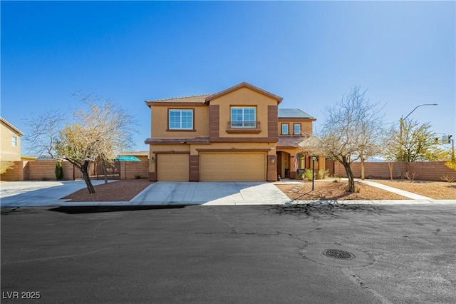 view of front facade with fence, a garage, driveway, and stucco siding