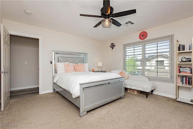 bedroom featuring visible vents, light carpet, baseboards, and ceiling fan