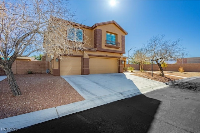 view of front of house featuring stucco siding, a garage, concrete driveway, and fence