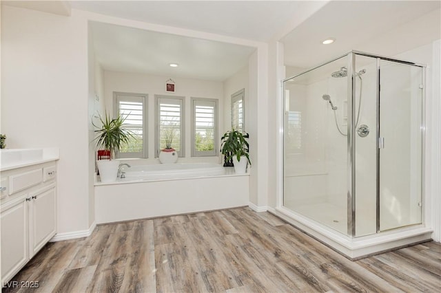 6391 Tempting Choice Ave, Las Vegas, NV 89131 - full bath with a shower stall, a bath, wood finished floors, vanity, and recessed lighting