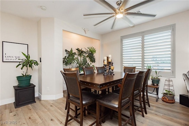 dining room featuring light wood-style flooring, ceiling fan, and baseboards