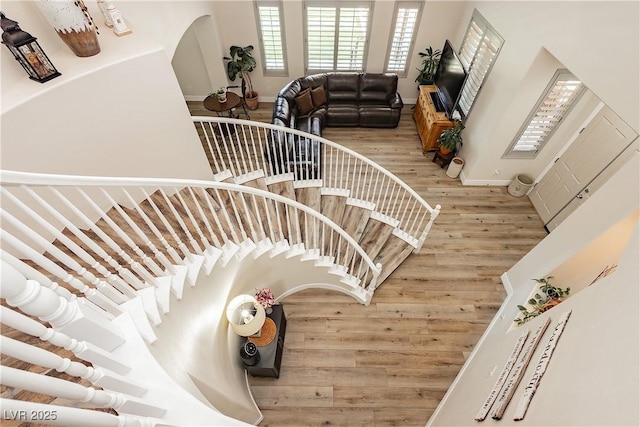 stairway with wood finished floors and baseboards