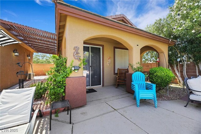 view of patio / terrace featuring a pergola and fence