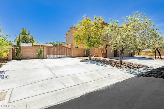 view of front facade featuring concrete driveway, a gate, and fence