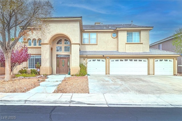 view of front of house with concrete driveway, an attached garage, and stucco siding