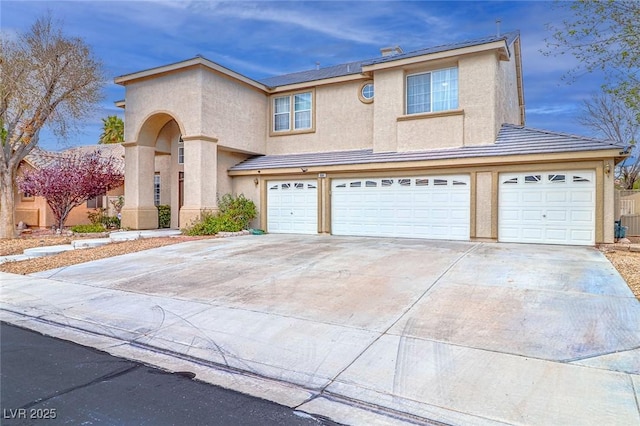 view of front of house featuring stucco siding, driveway, and an attached garage