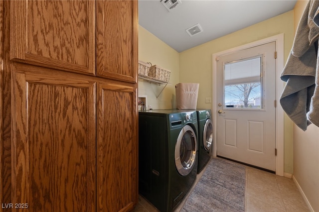 laundry area featuring independent washer and dryer, light tile patterned floors, baseboards, and visible vents