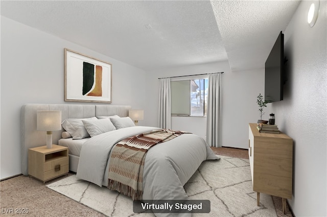 bedroom featuring light colored carpet and a textured ceiling