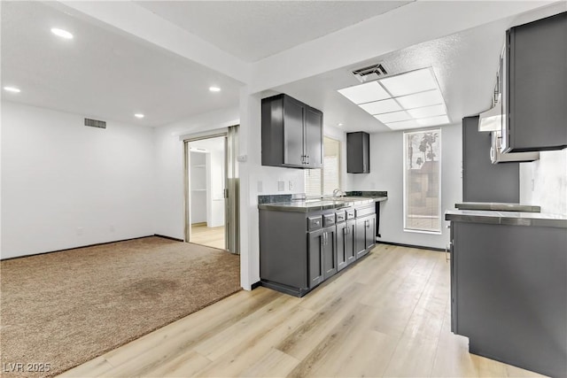 kitchen featuring recessed lighting, visible vents, and light wood-style flooring