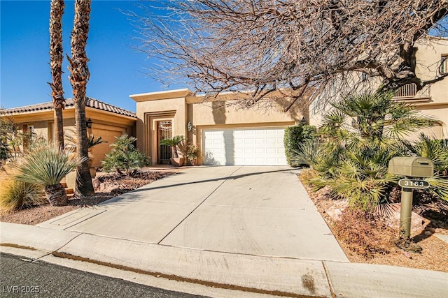 view of front facade featuring stucco siding, a garage, and concrete driveway