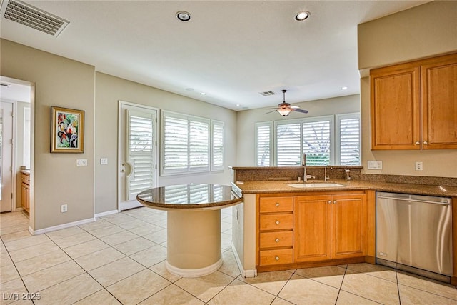 kitchen featuring visible vents, a sink, a peninsula, light tile patterned floors, and dishwasher