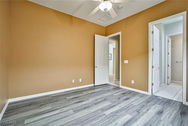 unfurnished bedroom featuring ceiling fan, baseboards, and wood finished floors