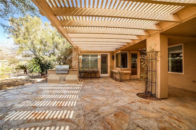 view of patio with exterior kitchen, area for grilling, and a pergola