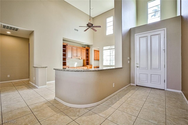 foyer with light tile patterned floors, visible vents, a healthy amount of sunlight, and ceiling fan