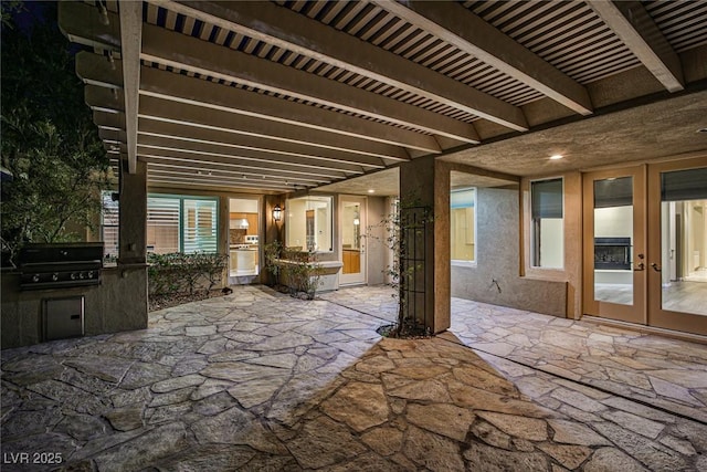 view of patio / terrace with grilling area, an outdoor kitchen, and french doors