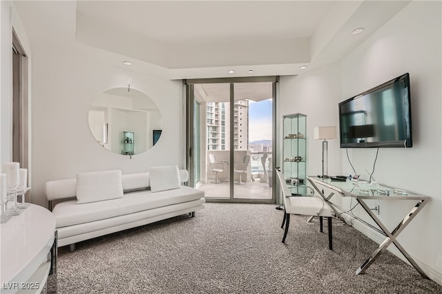 carpeted living area with recessed lighting