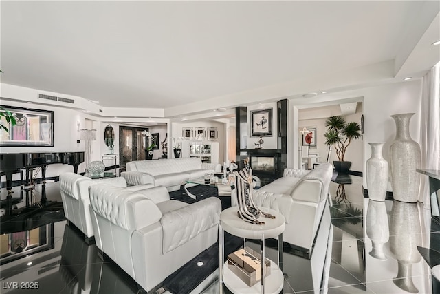 living area featuring visible vents and a multi sided fireplace