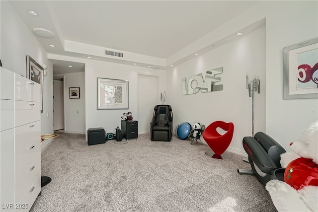 interior space featuring a raised ceiling, carpet flooring, recessed lighting, and visible vents