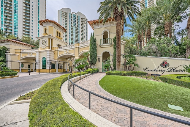 exterior space featuring a view of city, a tiled roof, and stucco siding