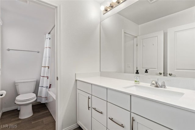 full bathroom featuring vanity, wood finished floors, baseboards, toilet, and shower / tub combo with curtain