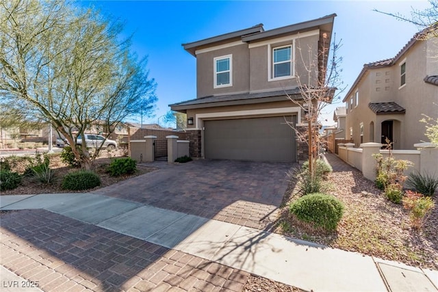 view of front facade featuring stucco siding, decorative driveway, stone siding, fence, and an attached garage