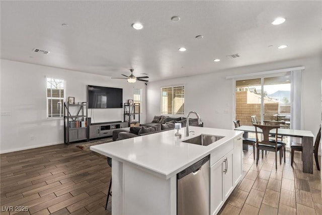 kitchen with dishwasher, wood tiled floor, plenty of natural light, and a sink