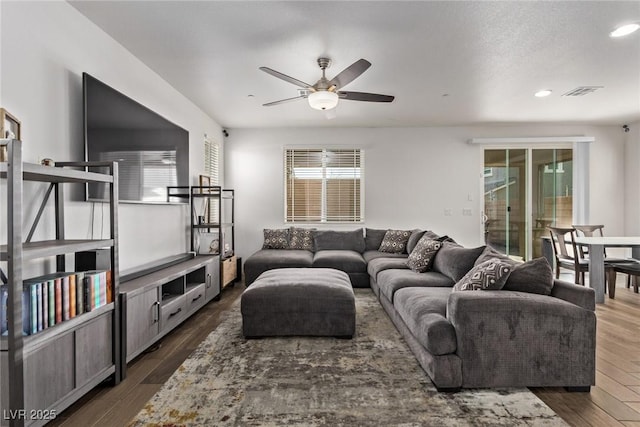 living room featuring visible vents, recessed lighting, dark wood-type flooring, and ceiling fan