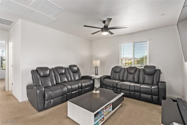 living area with visible vents, light colored carpet, and a healthy amount of sunlight