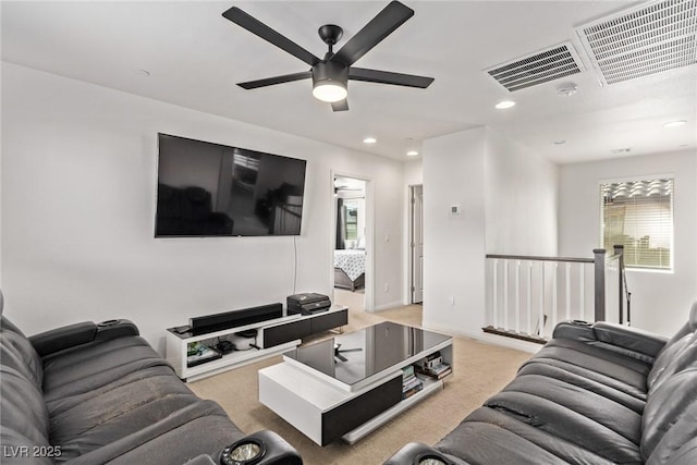 carpeted living area with visible vents, recessed lighting, a ceiling fan, and baseboards