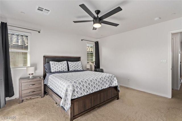 bedroom featuring a ceiling fan, light colored carpet, visible vents, and baseboards