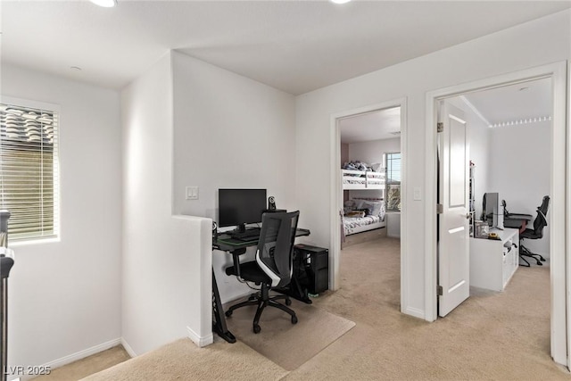 home office with baseboards and light carpet