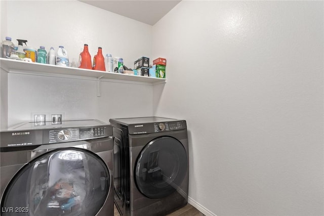 laundry room with laundry area, washer and dryer, baseboards, and wood finished floors