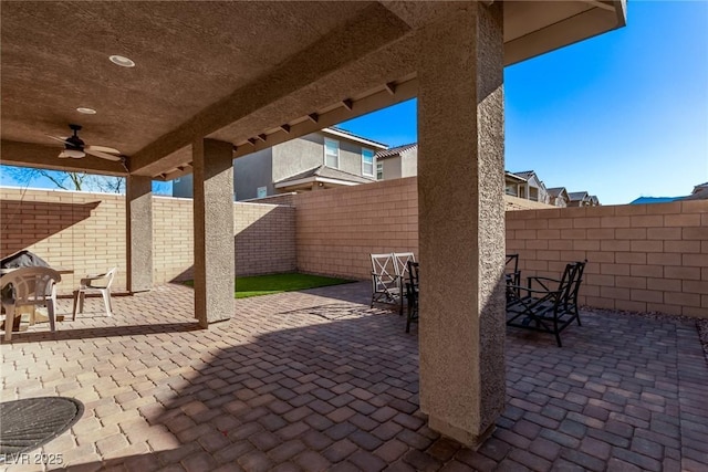 view of patio with ceiling fan, a fenced backyard, and outdoor dining space