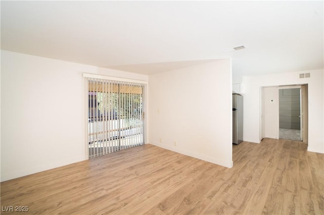 unfurnished room featuring visible vents and light wood-style floors