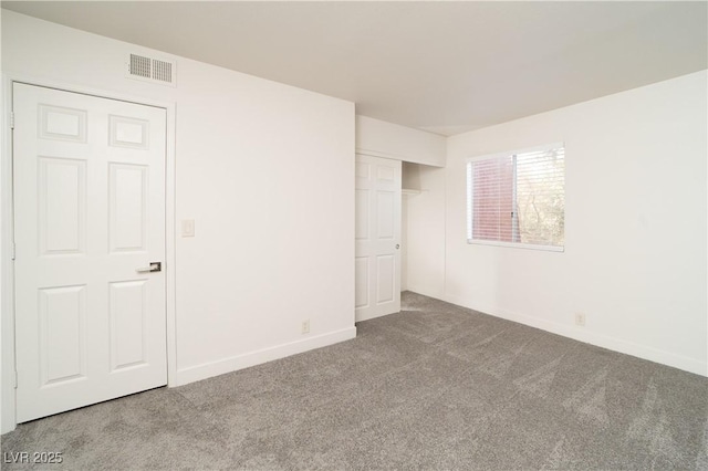 unfurnished bedroom with visible vents, carpet floors, baseboards, and a closet