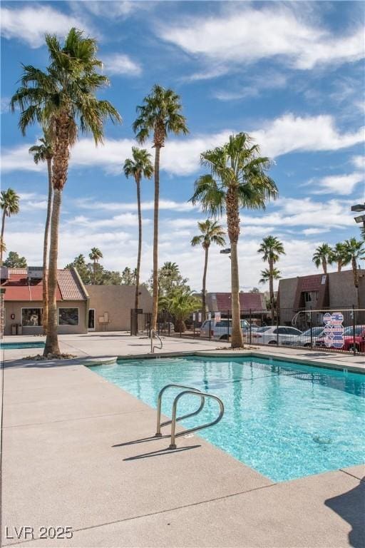 community pool featuring a patio area and fence