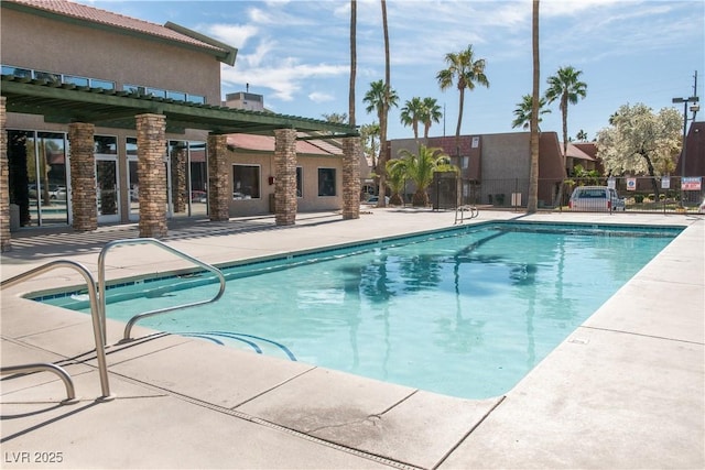 pool featuring a patio area and fence