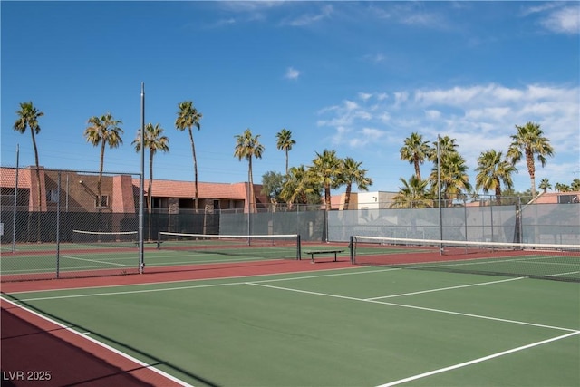 view of tennis court featuring fence