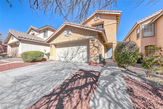 mediterranean / spanish-style house with concrete driveway, a tiled roof, a garage, and stucco siding