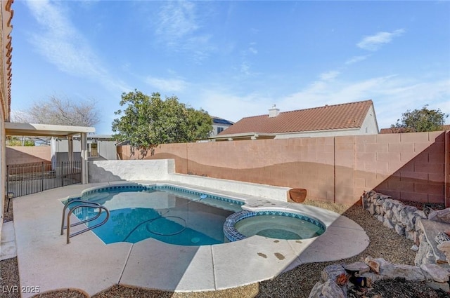 view of pool with a patio, a fenced backyard, and a pool with connected hot tub