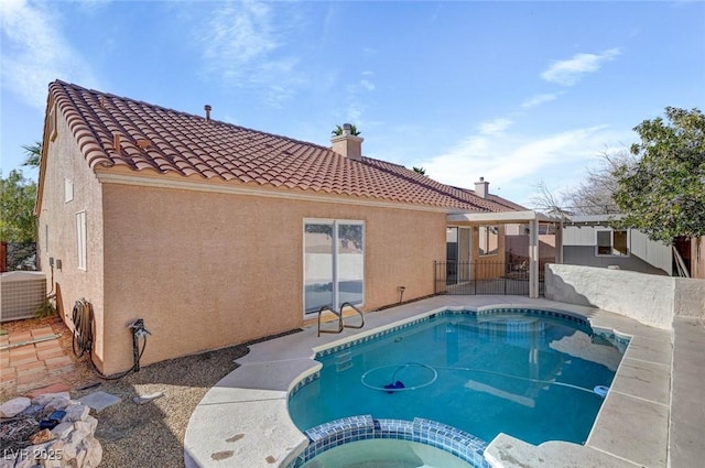 view of swimming pool featuring a patio, central AC unit, and a pool with connected hot tub