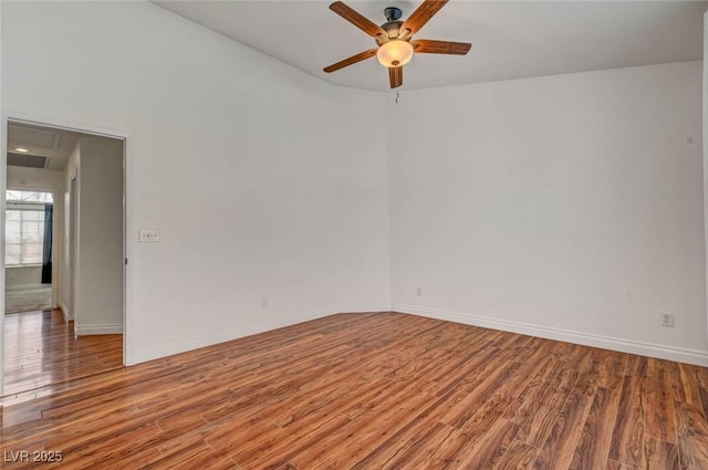 unfurnished room with baseboards and wood finished floors